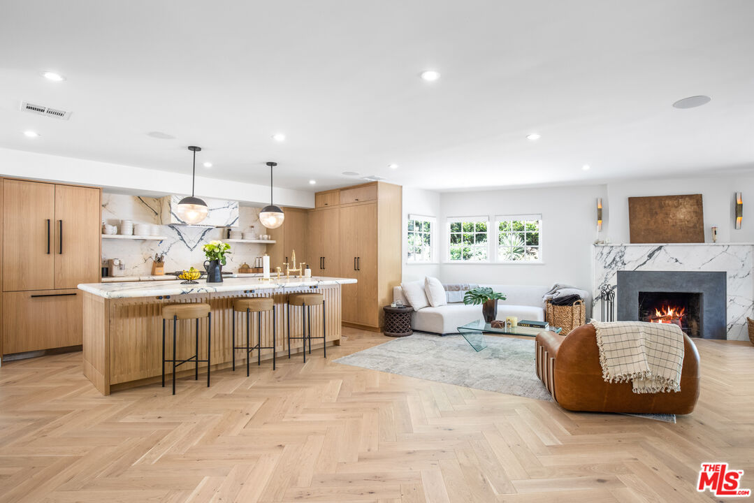 a living room with kitchen island furniture and a fireplace