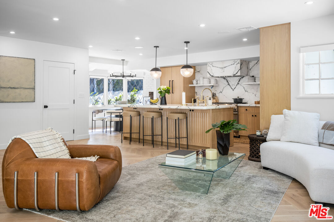 1570 Queens Road Los Angeles, CA 90069 - Photo 13 of 41 a living room with furniture kitchen view and a wooden floor