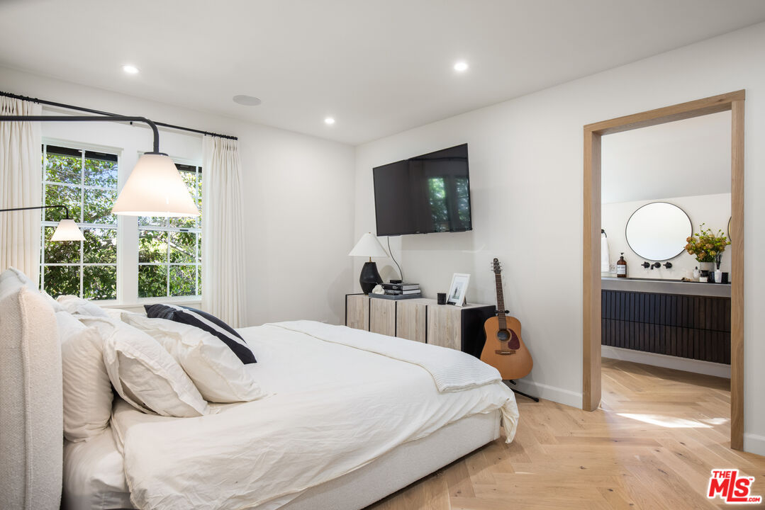 1570 Queens Road Los Angeles, CA 90069 - Photo 16 of 41 a bedroom with a bed and a flat tv screen on dresser