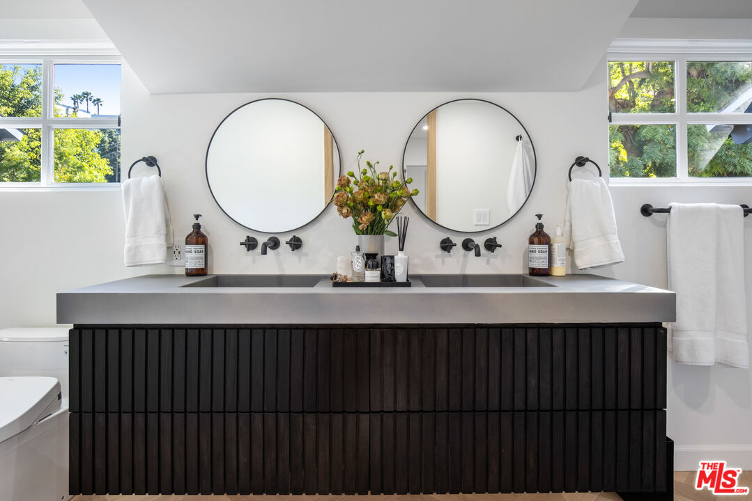 1570 Queens Road Los Angeles, CA 90069 - Photo 20 of 41 a bathroom with a double vanity sink and a mirror