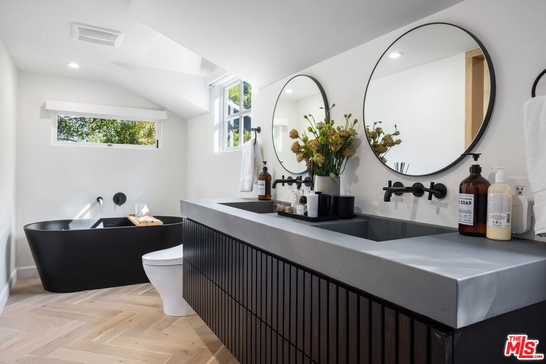 1570 Queens Road Los Angeles, CA 90069 - Photo 2 of 41 a bathroom with a double vanity sink and a mirror