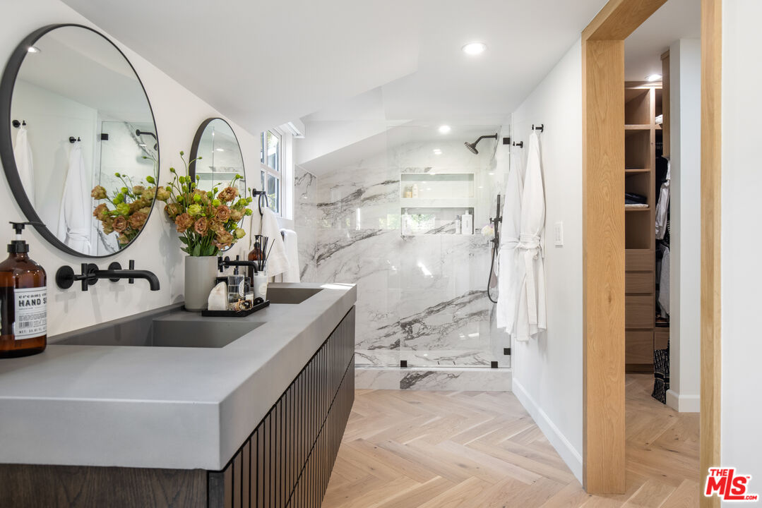 1570 Queens Road Los Angeles, CA 90069 - Photo 21 of 41 a bathroom with a sink a toilet and a mirror