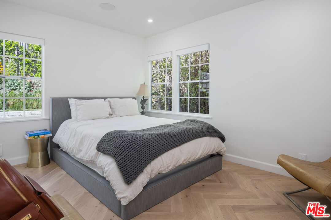 1570 Queens Road Los Angeles, CA 90069 - Photo 24 of 41 a large bed sitting in a bedroom next to a window