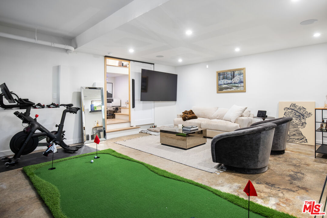 1570 Queens Road Los Angeles, CA 90069 - Photo 30 of 41 a living room with furniture a window and gym equipment