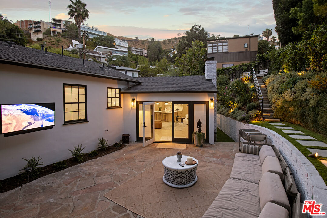 1570 Queens Road Los Angeles, CA 90069 - Photo 3 of 41 a front view of a house with outdoor seating