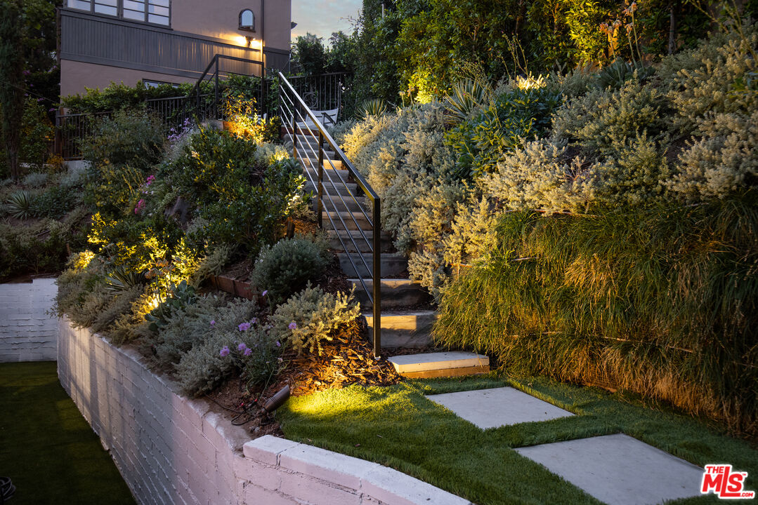 1570 Queens Road Los Angeles, CA 90069 - Photo 36 of 41 a view of a backyard with plants and large trees