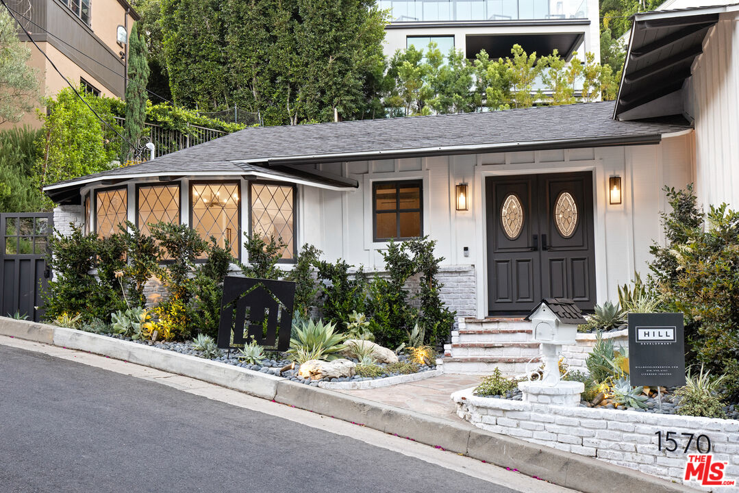 1570 Queens Road Los Angeles, CA 90069 - Photo 39 of 41 a front view of a house with garden