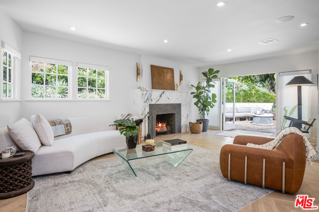 1570 Queens Road Los Angeles, CA 90069 - Photo 6 of 41 a living room with furniture a window and a fireplace