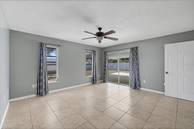 a view of an empty room with a ceiling fan