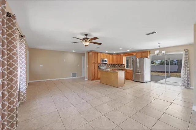 a view of a kitchen with furniture and an empty room