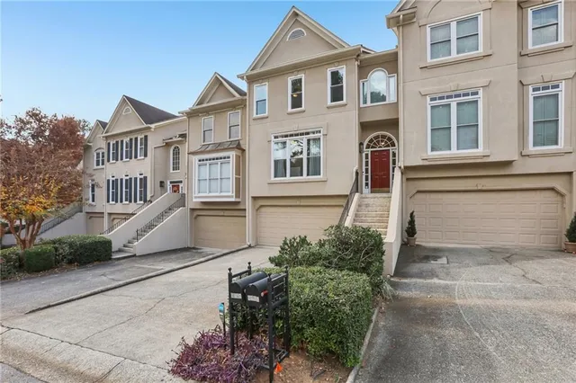 a view of a white house with large windows