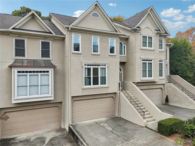 a view of a hallway with wooden floor and chandelier