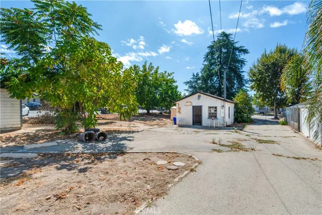 a dirt road with trees in the background