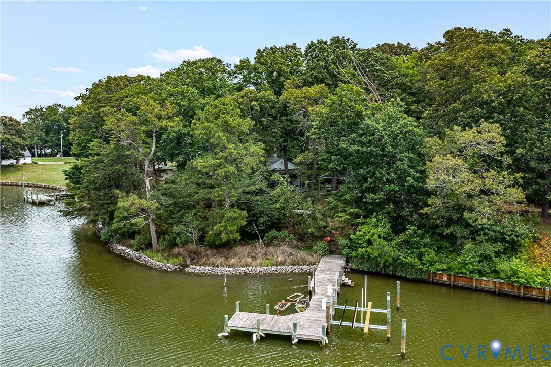 142 Bridge Lane Reedville, VA 22539 - Photo 33 of 56 a view of a lake with lawn chairs and large trees