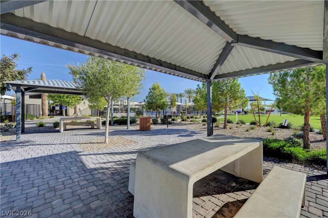 6924 Spicy Merlot Street North Las Vegas, NV 89086 - Photo 68 of 83 A well-appointed picnic area offers community gathering space amidst green landscaping and shade structures.