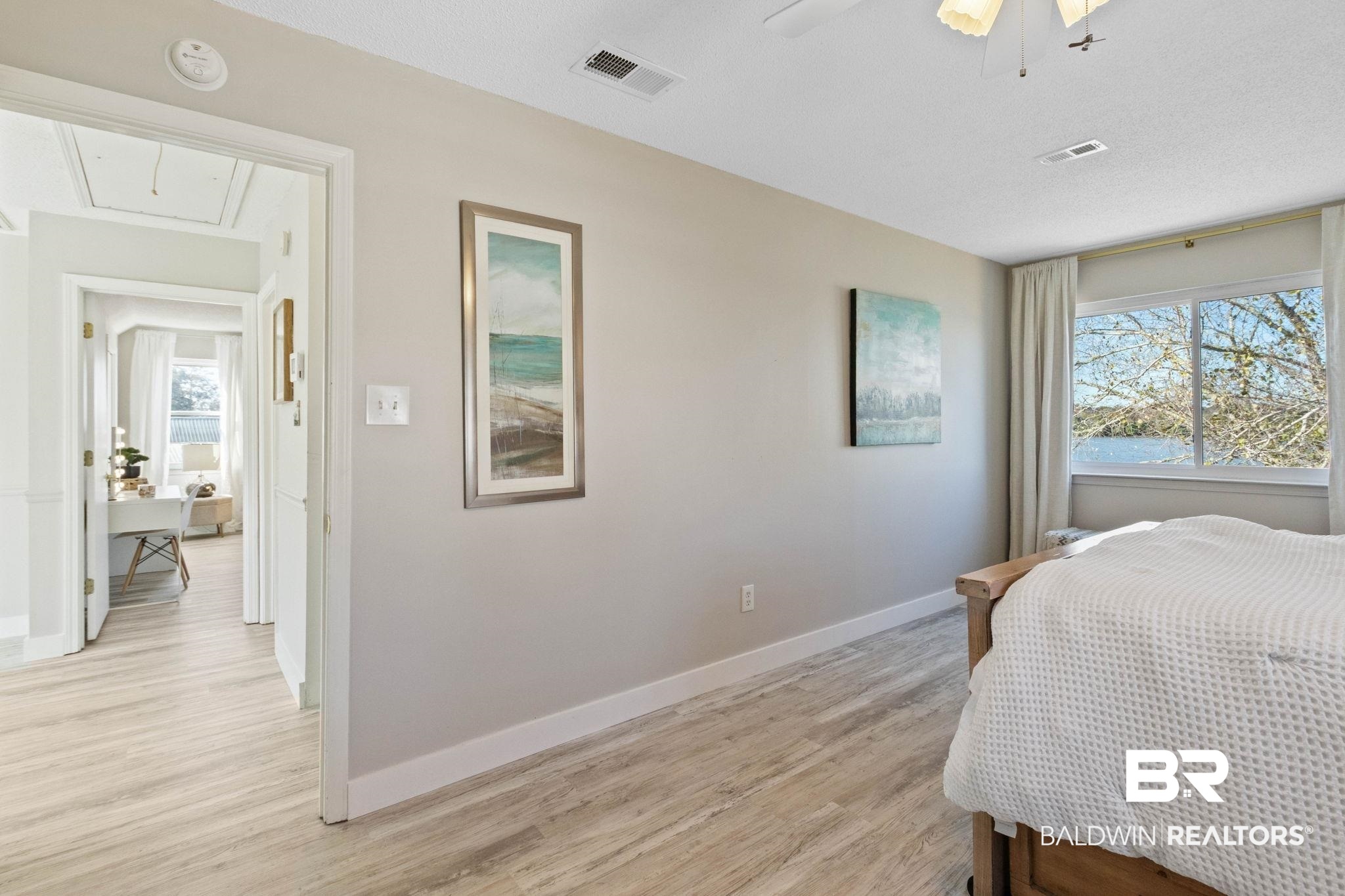 41997 Bayou Road Bay Minette, AL 36507 - Photo 44 of 68 Bedroom with attic access, light wood finished floors, a ceiling fan and a water view