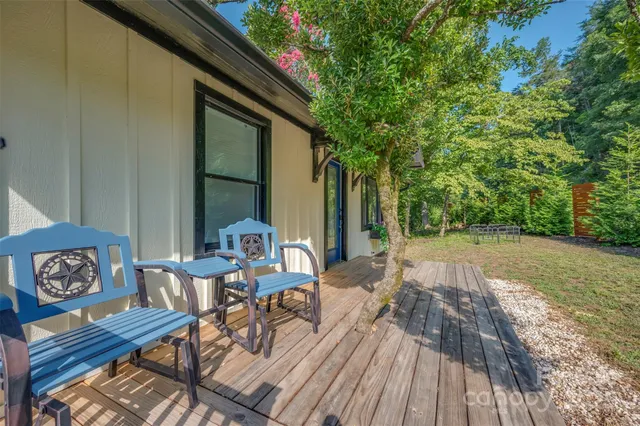 a living room with kitchen island granite countertop furniture and a wooden floor