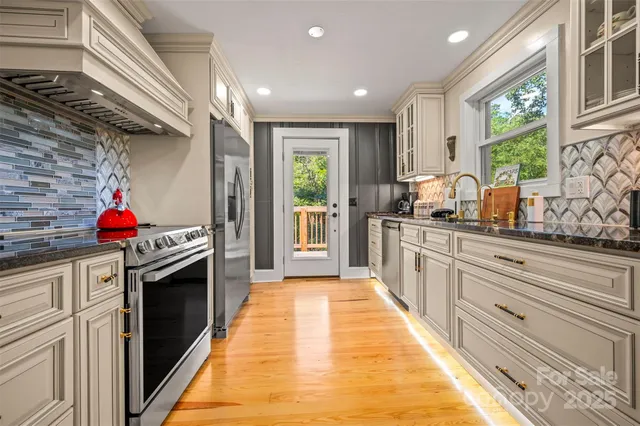 a bedroom with a bed and a lamp on dresser