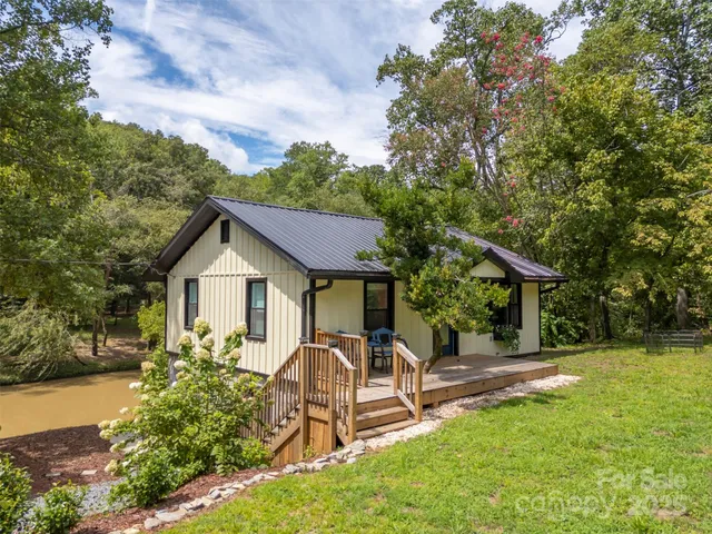 a view of a wooden fence next to a large tree