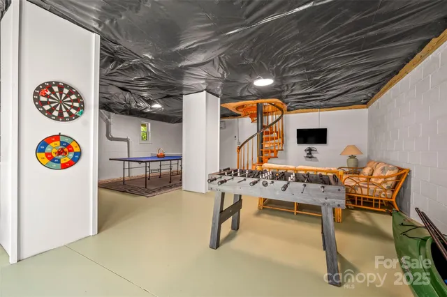 an aerial view of residential house with outdoor space and trees all around