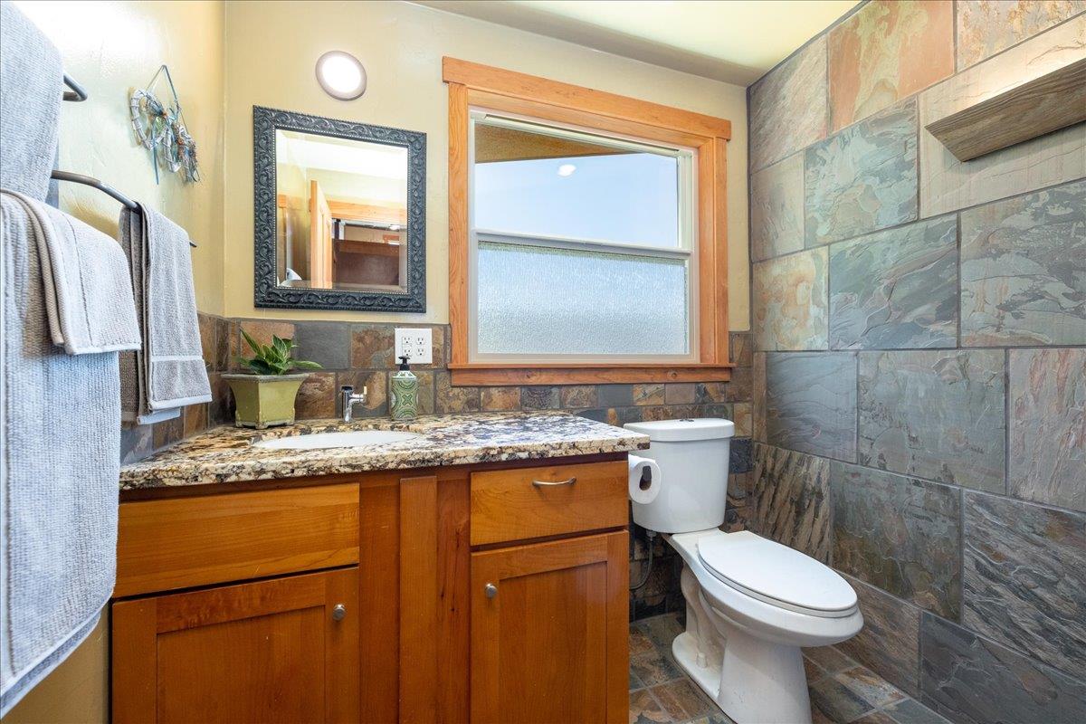 280 San Benito Road Brisbane, CA 94005 - Photo 22 of 63 a bathroom with a granite countertop toilet sink and mirror