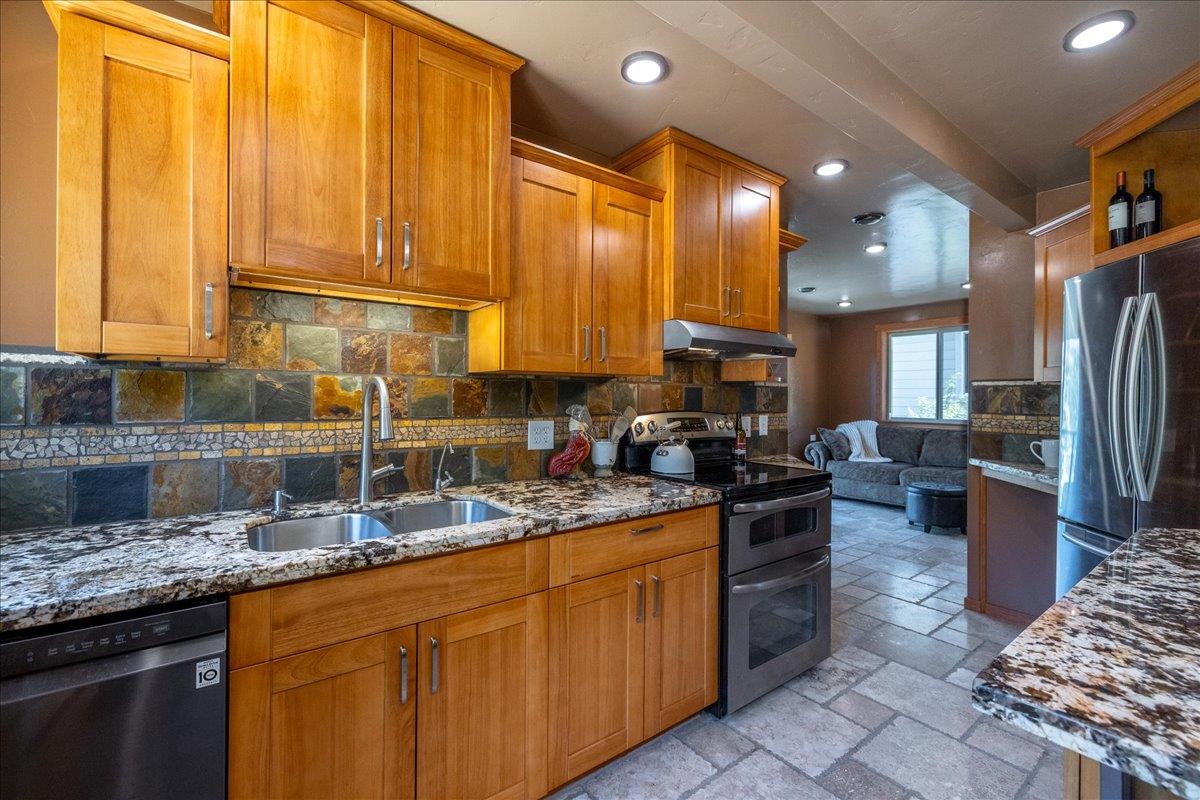 280 San Benito Road Brisbane, CA 94005 - Photo 28 of 63 a kitchen with stainless steel appliances granite countertop a stove a sink a refrigerator and blue cabinets with wooden floor