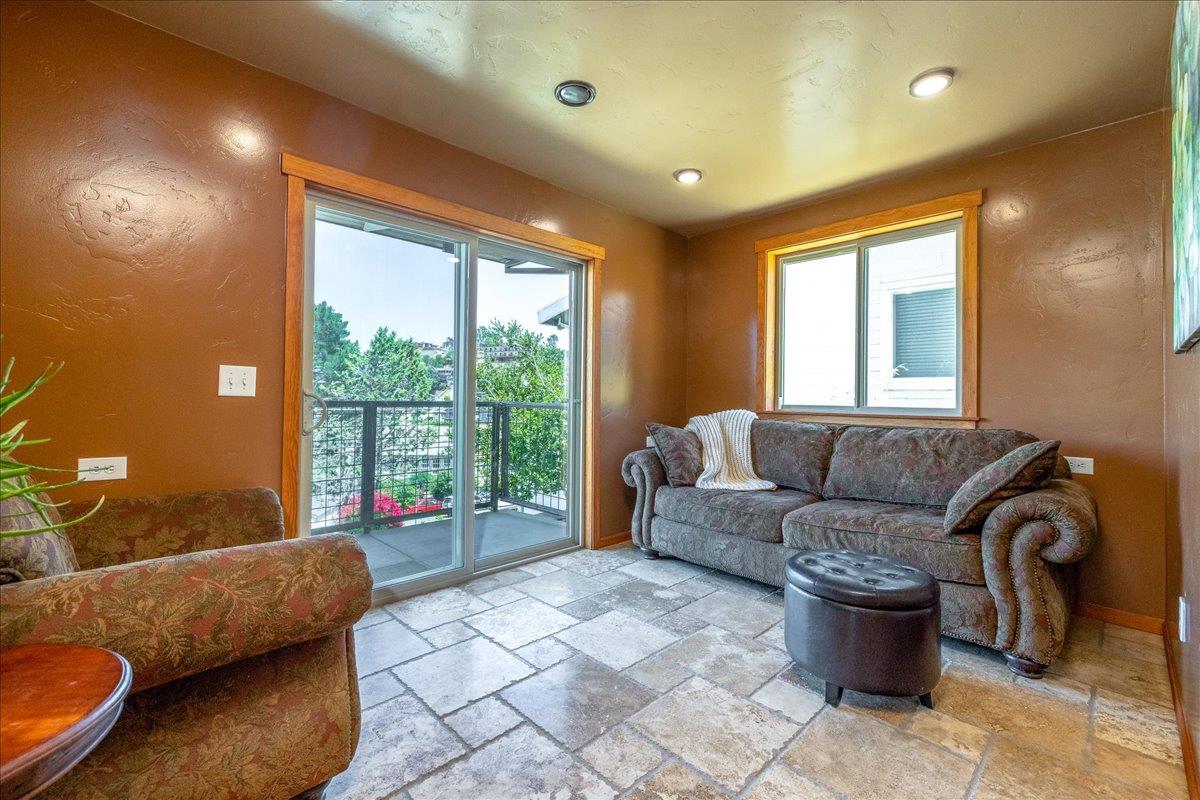 280 San Benito Road Brisbane, CA 94005 - Photo 29 of 63 a living room with furniture and a floor to ceiling window