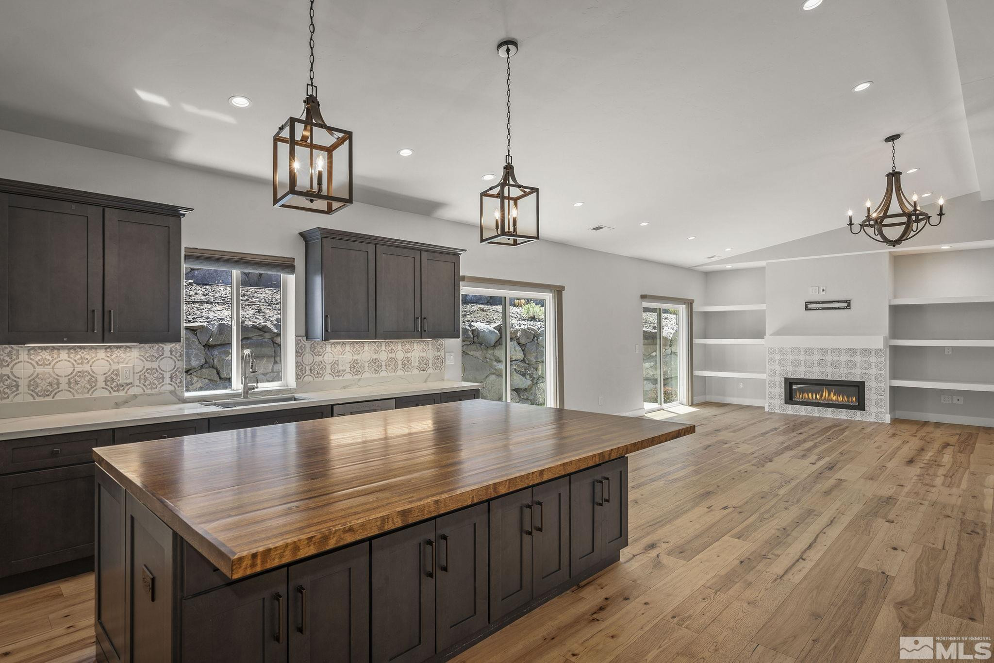 3880 Royer Court Reno, NV 89509 - Photo 12 of 29 a large kitchen with kitchen island a stove a sink a counter space and wooden floor