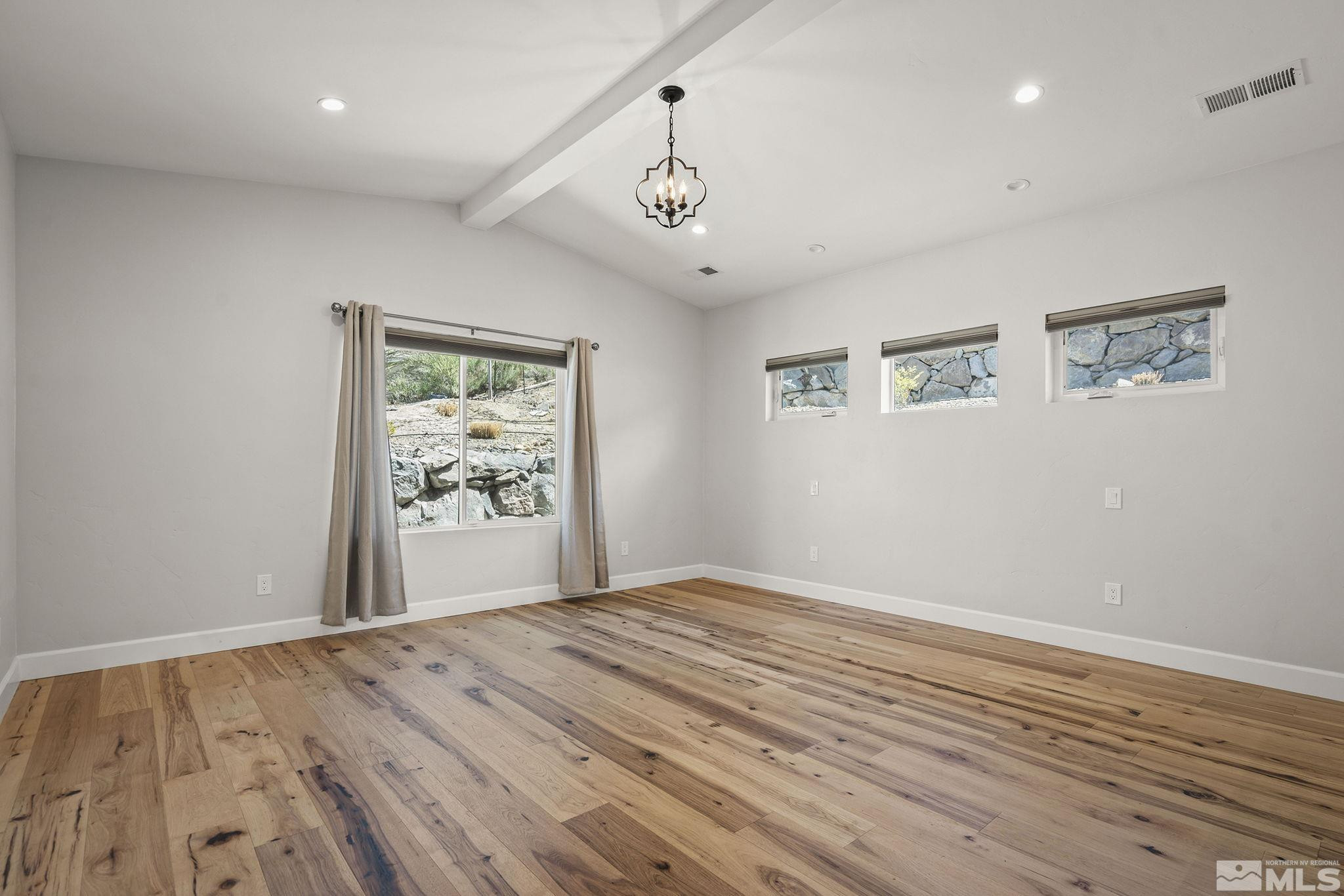 3880 Royer Court Reno, NV 89509 - Photo 13 of 29 a view of an empty room with window and wooden floor