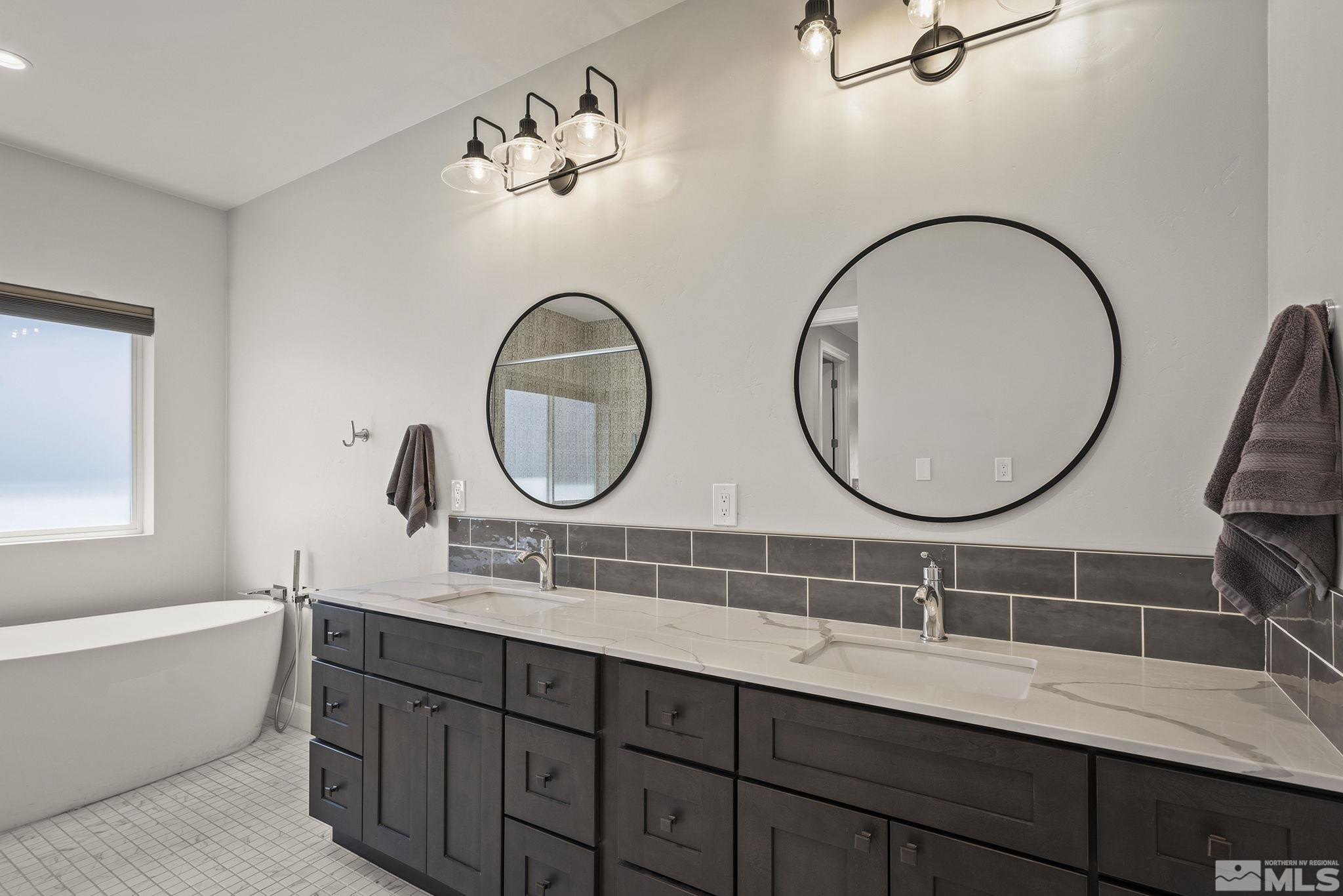 3880 Royer Court Reno, NV 89509 - Photo 14 of 29 a bathroom with a double vanity sink and a mirror