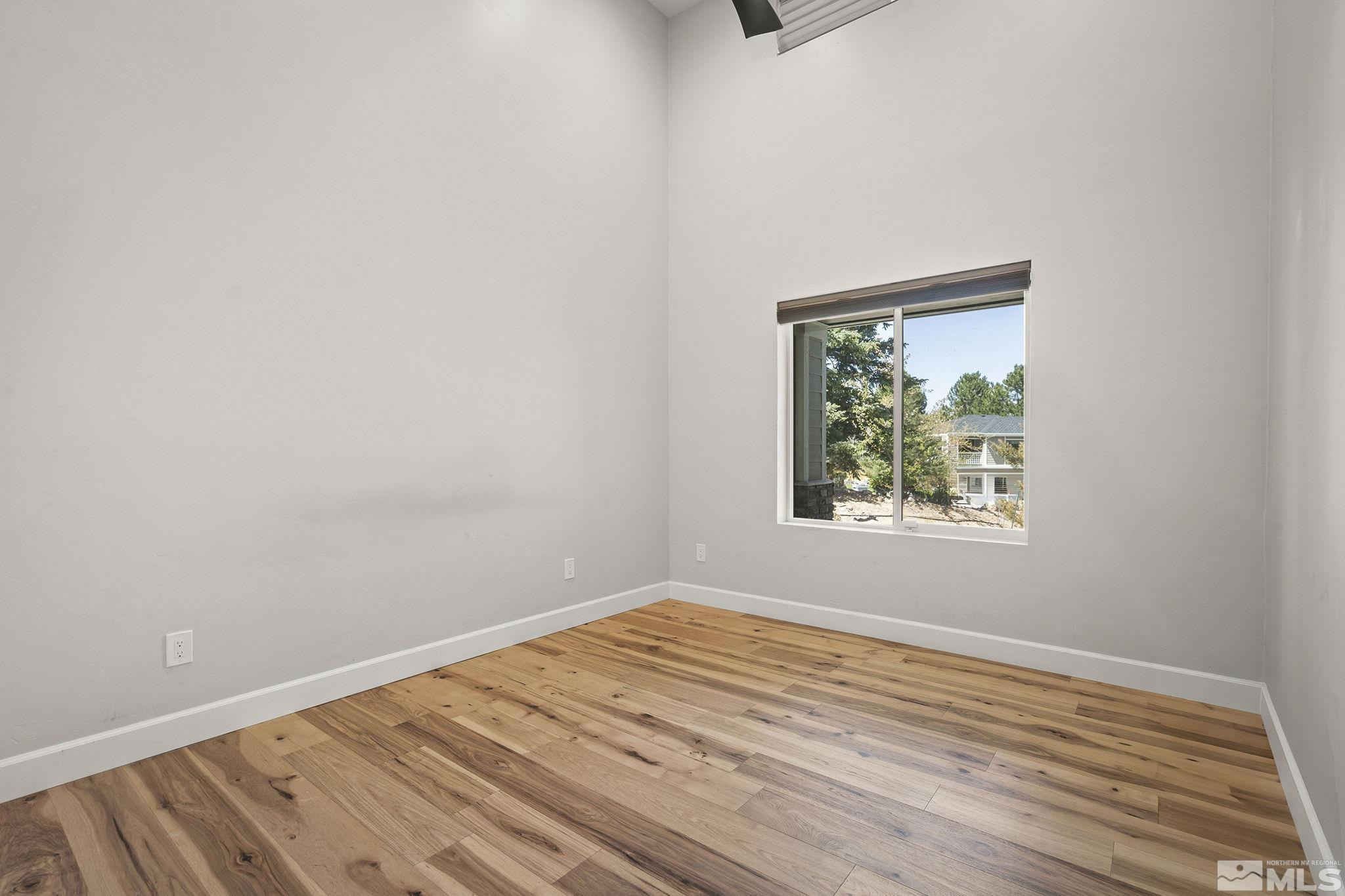 3880 Royer Court Reno, NV 89509 - Photo 17 of 29 a view of an empty room with wooden floor and a window