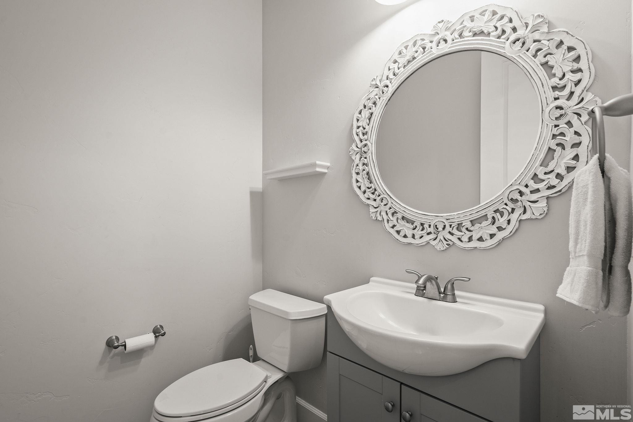 3880 Royer Court Reno, NV 89509 - Photo 21 of 29 a bathroom with a toilet sink mirror and vanity