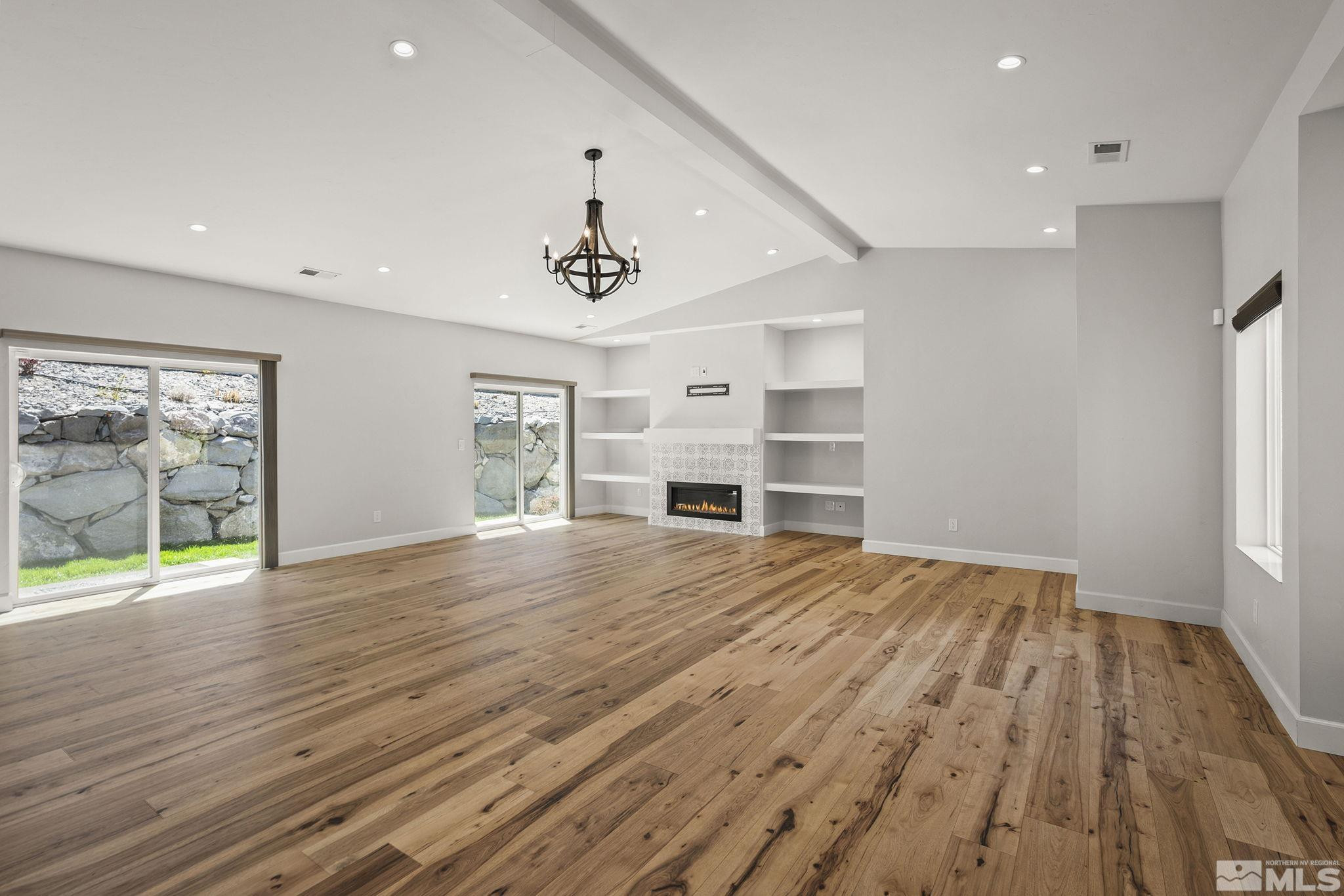 3880 Royer Court Reno, NV 89509 - Photo 7 of 29 a view of an empty room with a window and wooden floor