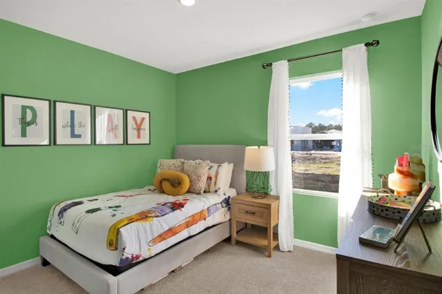 a bedroom with a bed and wall painting