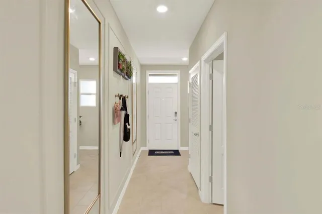 a view of a hallway with closet and wooden floor