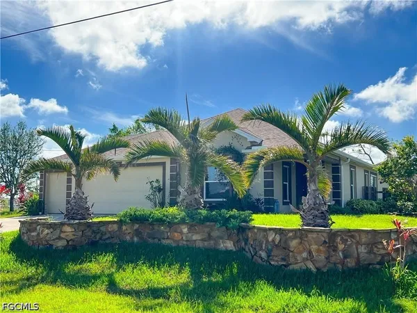 a view of a house with swimming pool and a yard