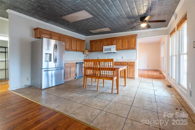 a kitchen with stainless steel appliances granite countertop a refrigerator and a stove top oven
