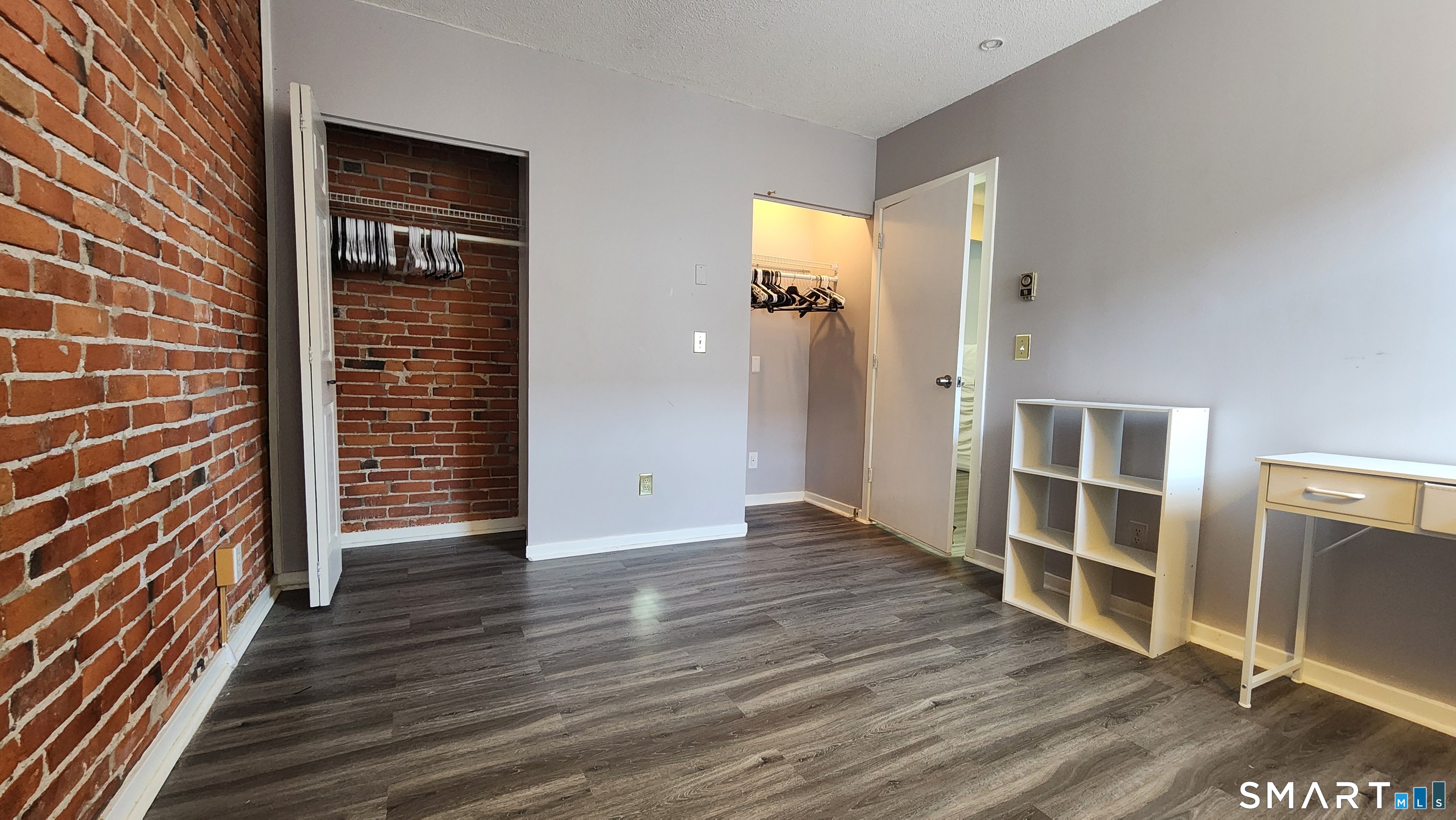 18 Townley Street, Unit D3 Hartford, CT 06105 - Photo 8 of 10 an empty room with wooden floor closet and windows