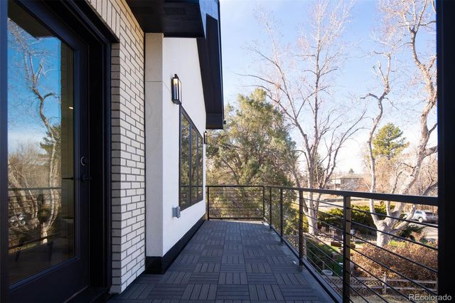 a view of balcony with wooden floor and fence