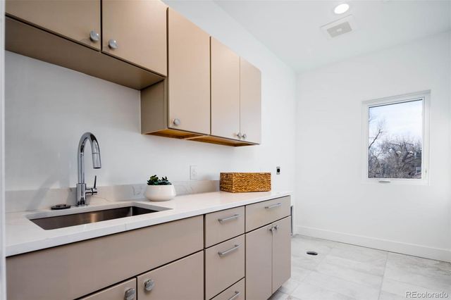 a kitchen with a sink and cabinets