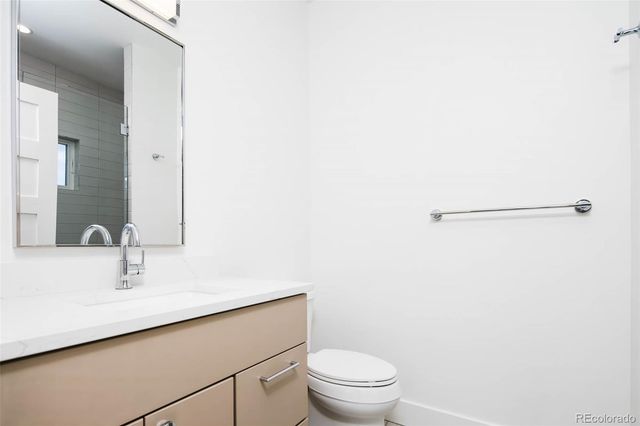 a bathroom with a sink a toilet and mirror