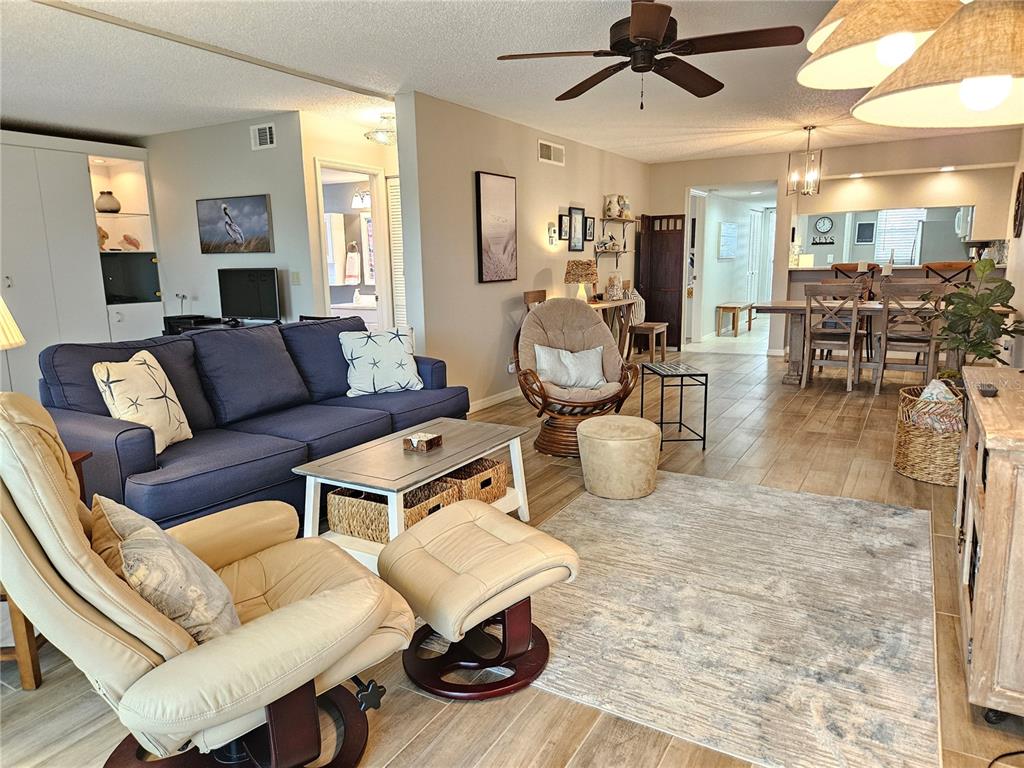 435 Cerromar Lane, Unit 329 Venice, FL 34293 - Photo 16 of 57 a living room with furniture and a large window
