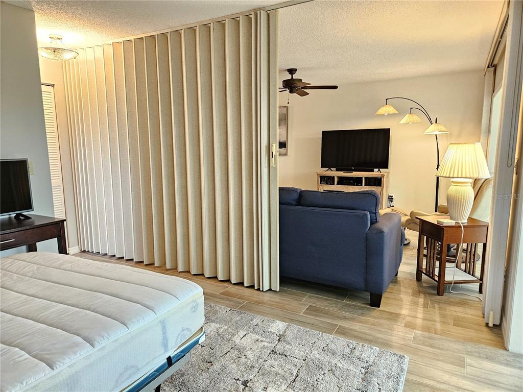 435 Cerromar Lane, Unit 329 Venice, FL 34293 - Photo 23 of 57 a bedroom with a bed and a television