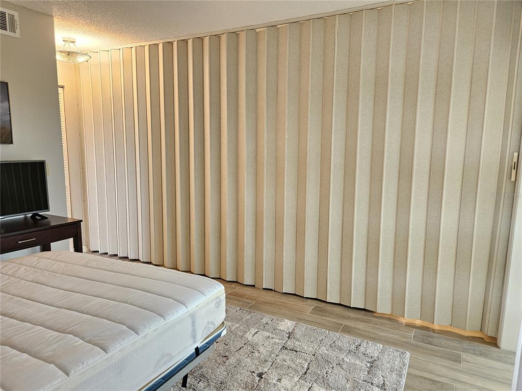 435 Cerromar Lane, Unit 329 Venice, FL 34293 - Photo 24 of 57 a bedroom with bed and a flat tv screen