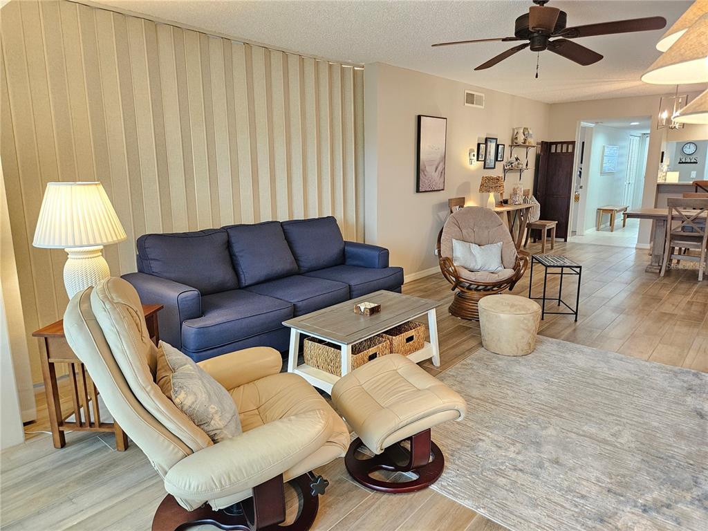435 Cerromar Lane, Unit 329 Venice, FL 34293 - Photo 27 of 57 a living room with furniture and a window