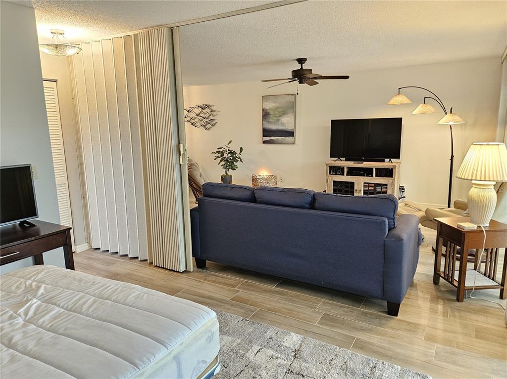 435 Cerromar Lane, Unit 329 Venice, FL 34293 - Photo 29 of 57 a bedroom with a bed and flat screen tv