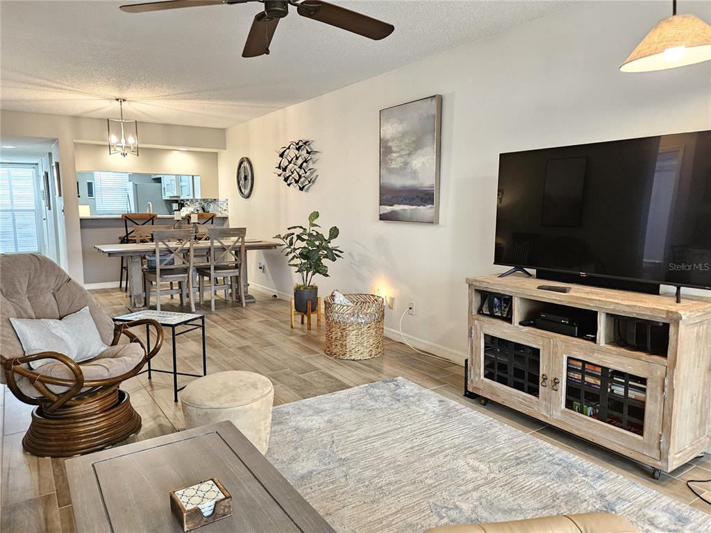 435 Cerromar Lane, Unit 329 Venice, FL 34293 - Photo 32 of 57 a living room with furniture and a flat screen tv