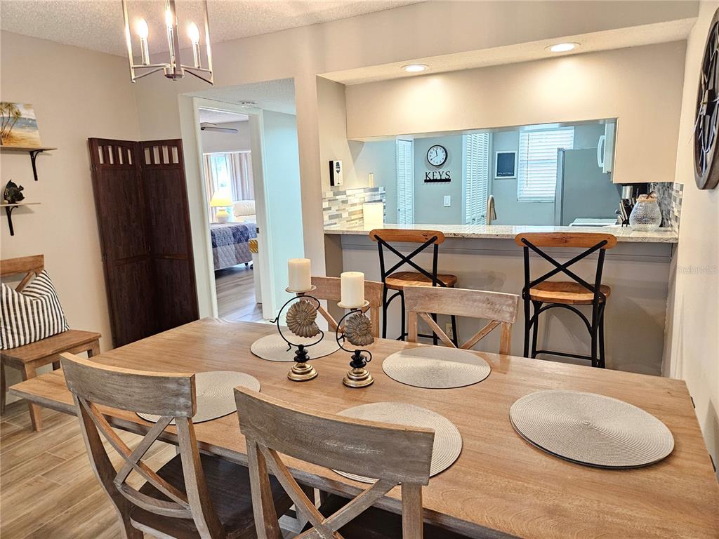 435 Cerromar Lane, Unit 329 Venice, FL 34293 - Photo 36 of 57 a view of a dining room with furniture and a chandelier