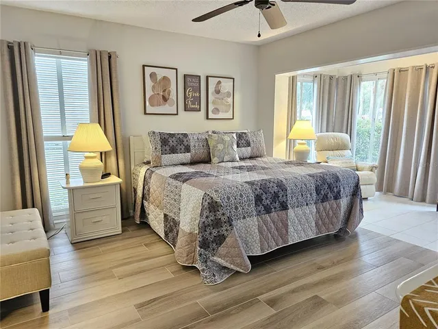 a bedroom with a bed and large window