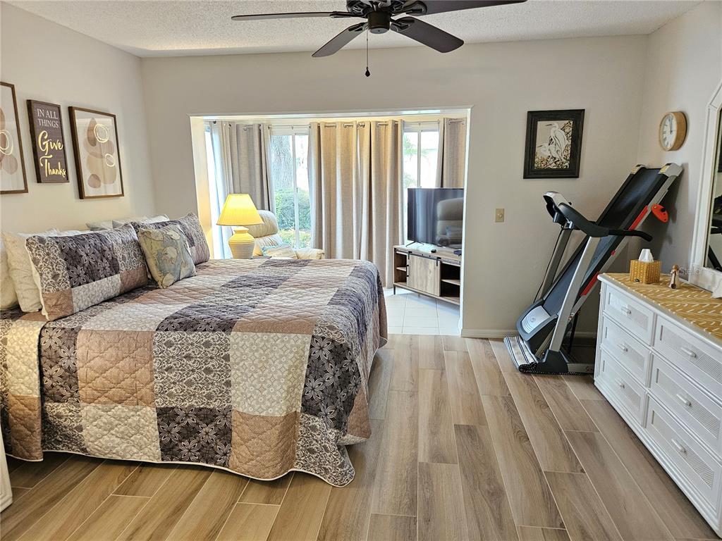 435 Cerromar Lane, Unit 329 Venice, FL 34293 - Photo 40 of 57 a bedroom with a bed and wooden floor